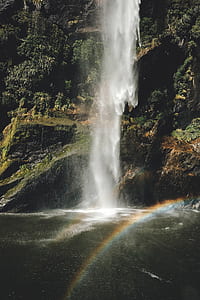 photo of waterfalls on brown and black cliff thumbnail