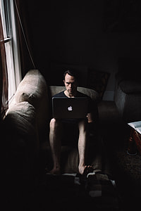 photo of man sitting with MacBook thumbnail